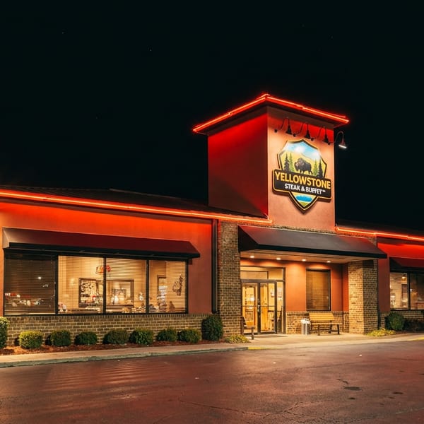 Yellowstone Steak & Buffet restaurant exterior at night with bright red neon lights.